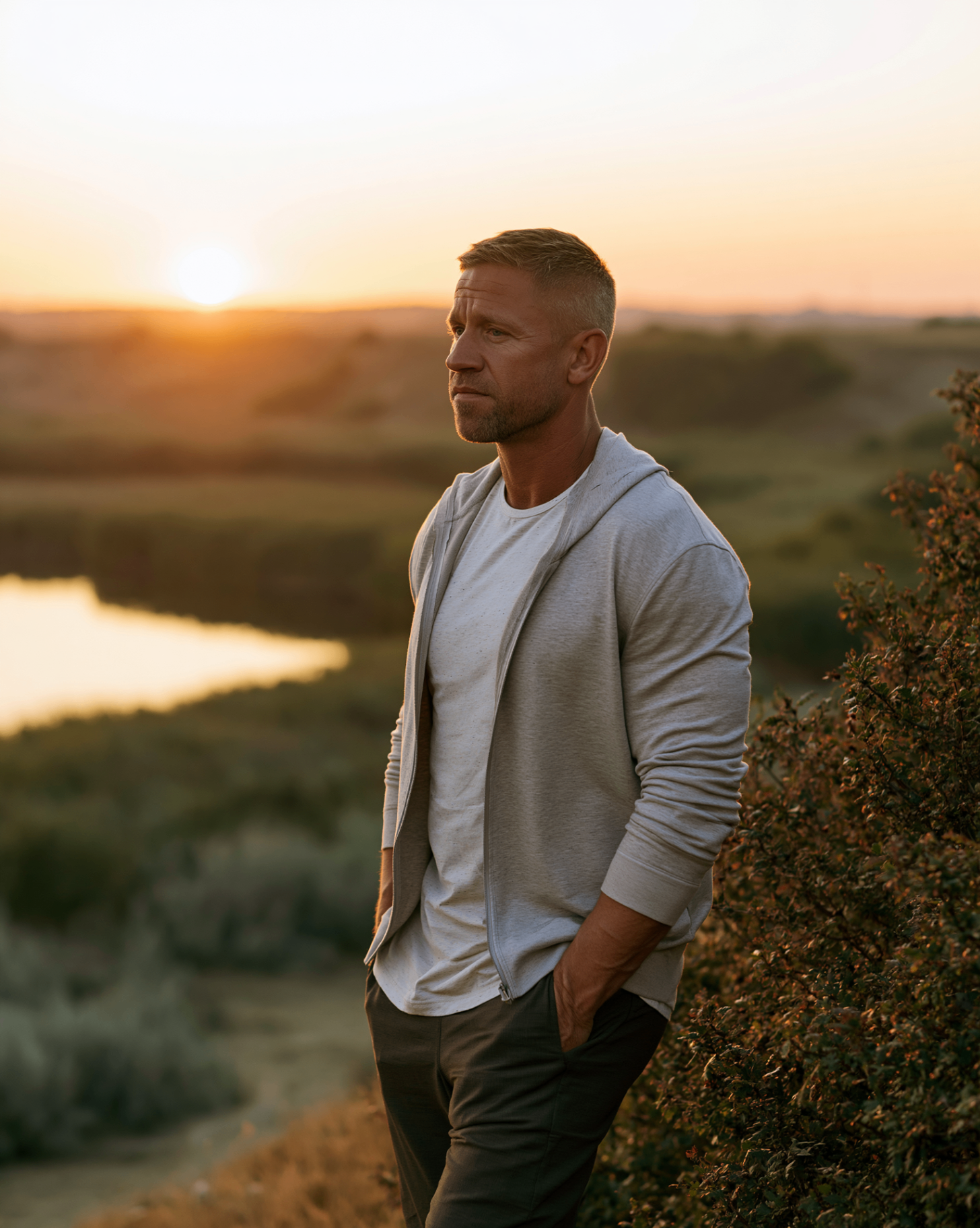 Man at sunset overlooking a river and wetlands